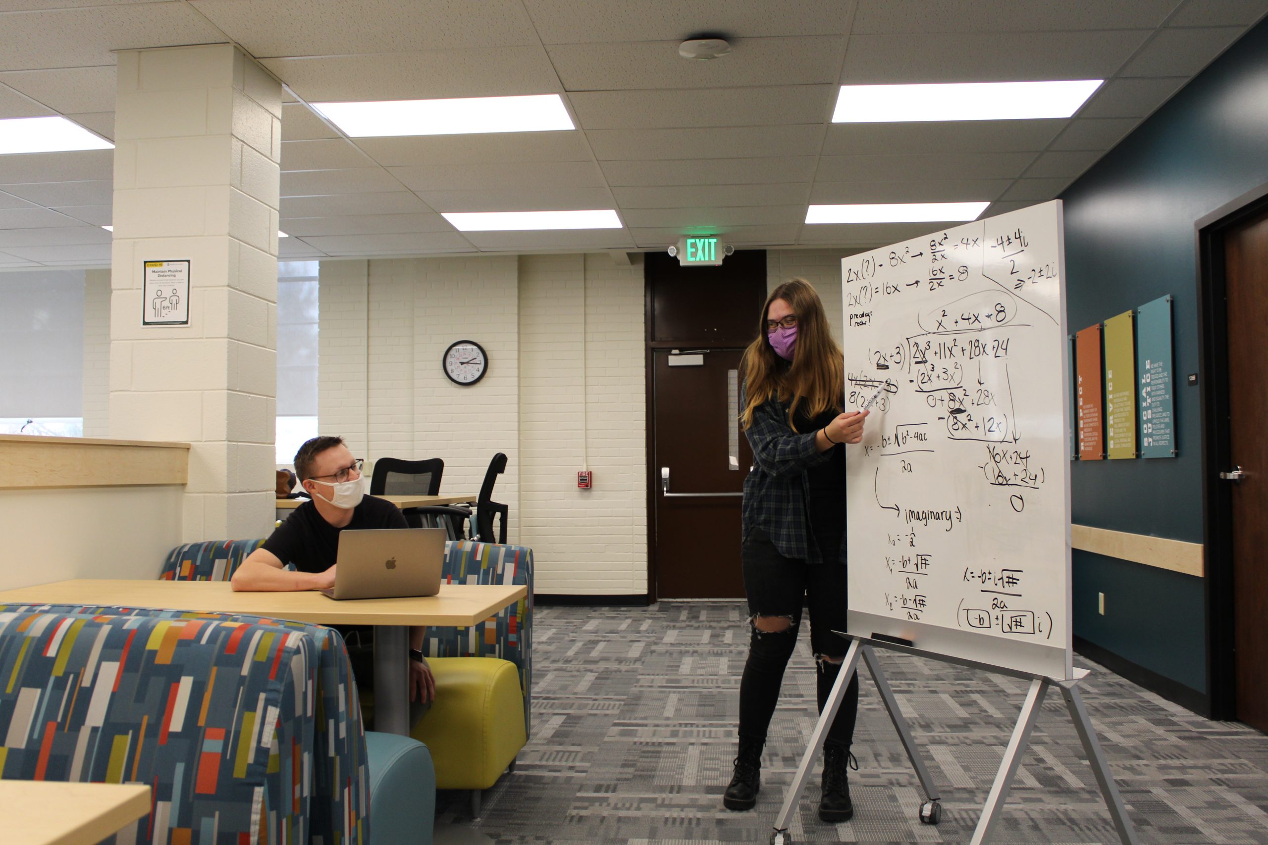 img_3371 A mathematics tutor helps a student.