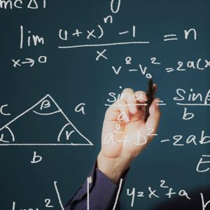 Photo of a hand writing math equations and formulas on an invisible whiteboard.