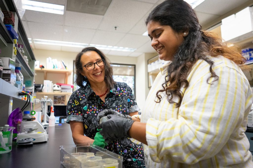 A research faculty member and a student work together in a lab.