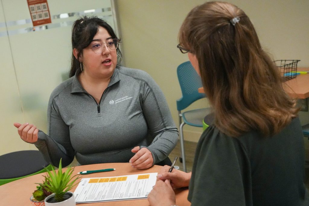 A student talks to a staff member in the CSU Career Center.